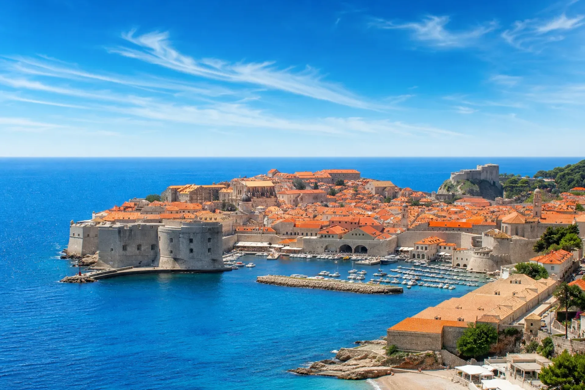 Italy, Croatia, Montenegro, Greece-The ancient stone walls and red roofs of Dubrovnik seen on an Adriatic Greece cruise.