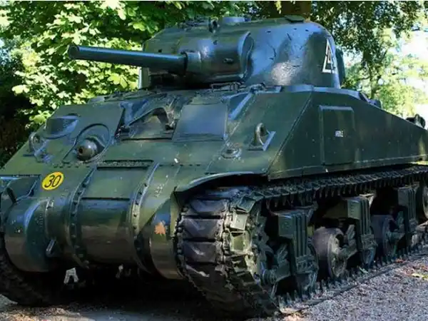 A restored green M4 Sherman tank, representing the Allied armour explored on our WW2 Airborne and Battle of the Bulge battlefield tours.